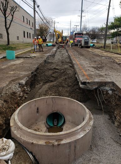 street cut to reveal sanitary sewer pipe
