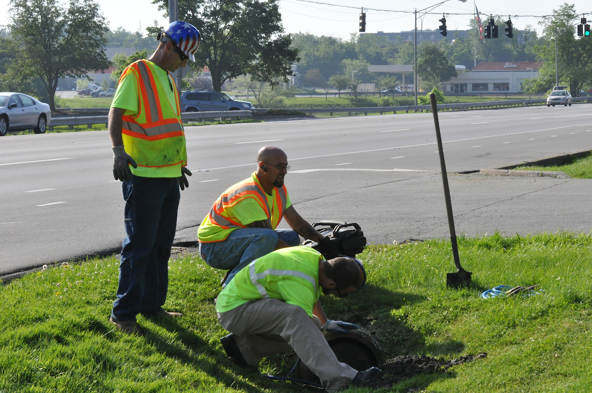Workers repair a portion of sewer