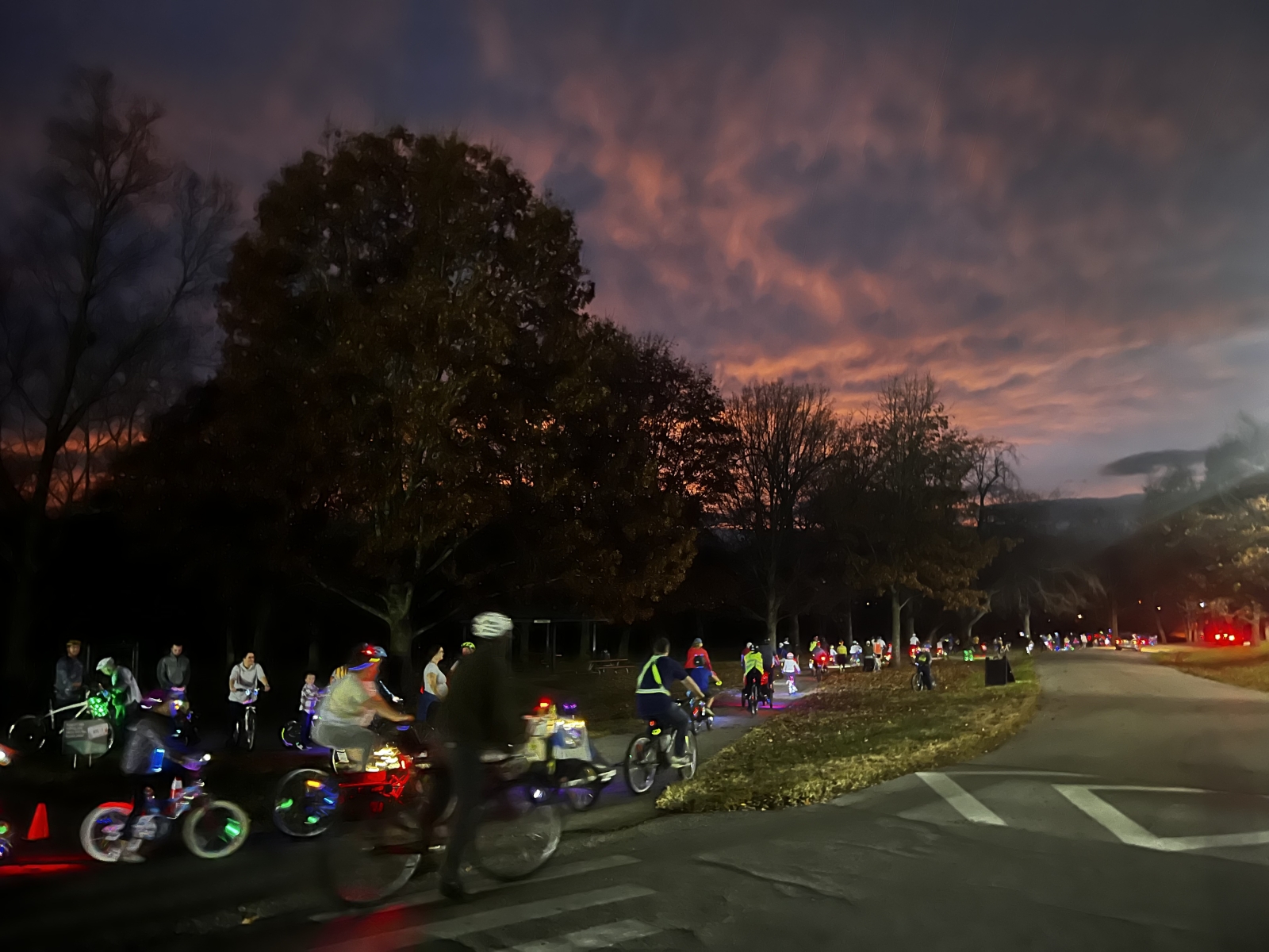 Cyclists get ready to ride a light path at dusk during Lex Glow Ride