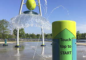 outdoor fountain park, with short pole showing a sticker pointing to top of pole
