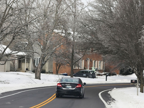 Car driving on a snow-cleared road. 