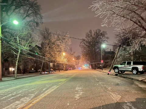 ice and snow covered street with low hanging power lines across it