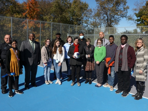 Mayor Linda Gorton, Council Member James Brown, city government officials and Winburn Middle School children pose at the ribbon-cutting ceremony for the new futsal court at MLK Park