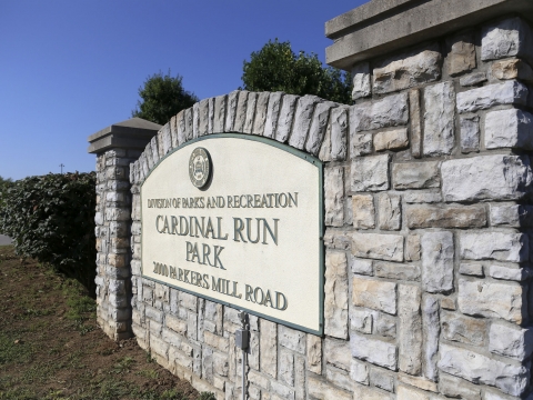 large stone sign in a grassy field that reads Cardinal Run Park