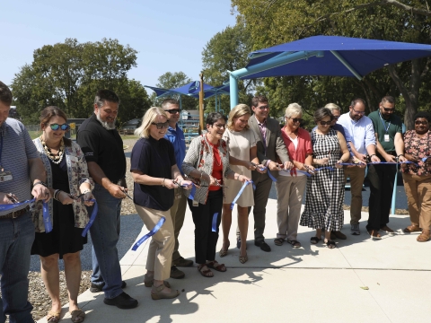 Mayor Gorton, councilmembers, Parks staff and other partners cut a ribbon at the new playground