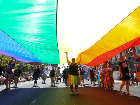 Person standing under pride flag.