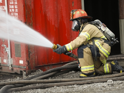 Lexington firefighter spraying hose at the Fire Training Center