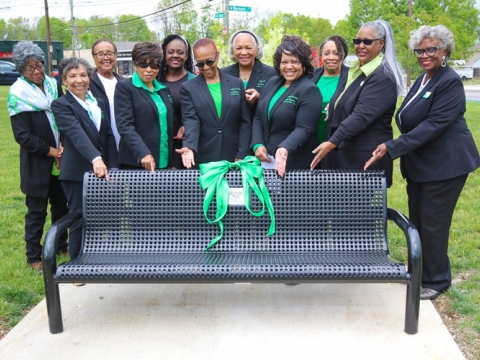 Members of The Links, Incorporated point to a Positivity Bench they donated to Charles Young Park