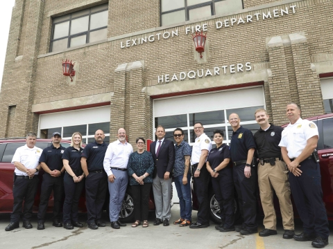 Mayor Linda Gorton, Rep. Andy Barr, Chief Jason Wells and members of the Community Paramedicine program pose for a photo in front of two red vans