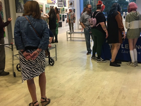 Individuals looking at artwork