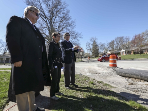 Director of Water Quality Charlie Martin, Mayor Linda Gorton and Councilmember Fred Brown examine a temporary sewer pipe across the street. 